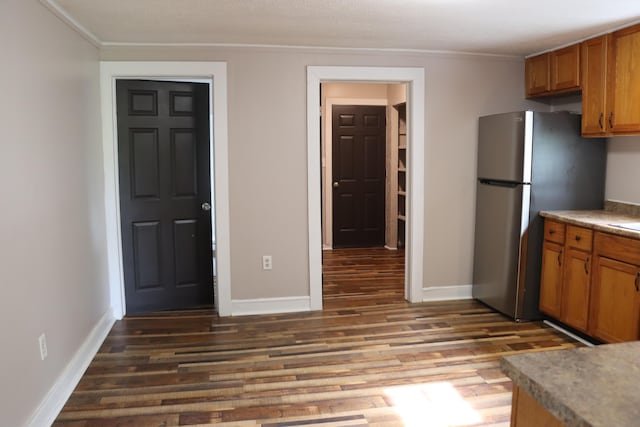 2721 E Ringgold, Somerset, KY 42503 - kitchen with crown molding, freestanding refrigerator, brown cabinetry, and wood finished floors
