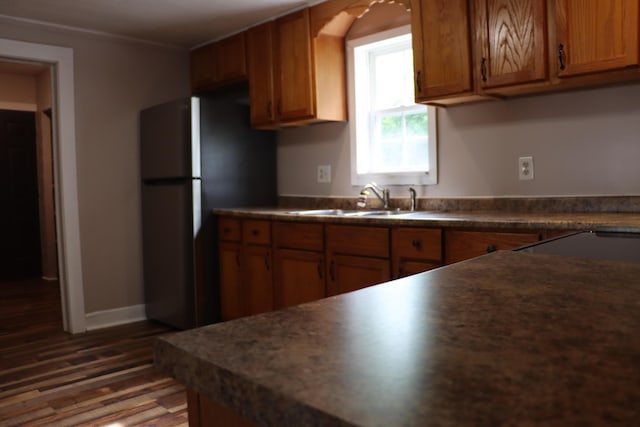 2721 E Ringgold, Somerset, KY 42503 - kitchen featuring freestanding refrigerator, wood finished floors, dark countertops, brown cabinetry, and ornamental molding