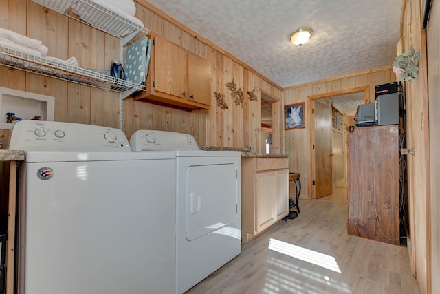 69 Side Run Rd, Wellington, KY 40387 - laundry area featuring washing machine and clothes dryer, cabinet space, wood walls, and light wood finished floors