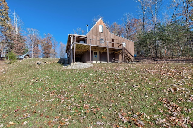 69 Side Run Rd, Wellington, KY 40387 - back of property with stairs, a wooden deck, a yard, and board and batten siding