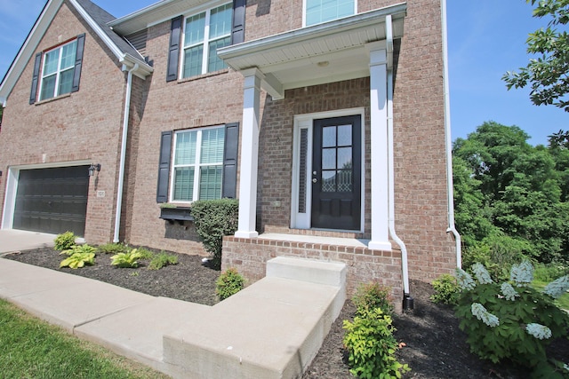 101 Corolla Cir, Georgetown, KY 40324 - doorway to property featuring a garage, brick siding, and concrete driveway