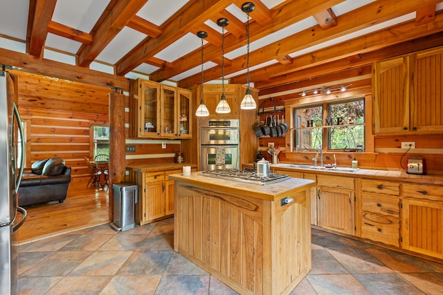 1836 Red Lick Rd, Berea, KY 40403 - kitchen featuring appliances with stainless steel finishes, tile countertops, a center island, beamed ceiling, and light stone finish floors