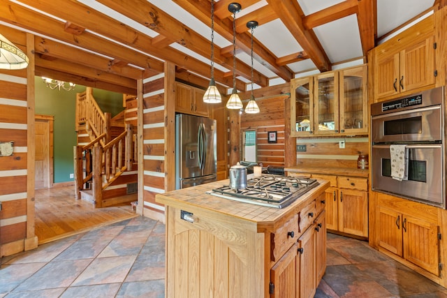 1836 Red Lick Rd, Berea, KY 40403 - kitchen with stainless steel appliances, a center island, wooden walls, dark stone finish floors, and glass insert cabinets