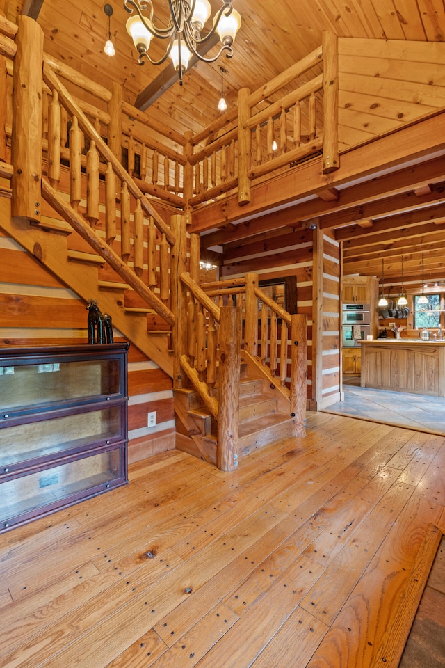 1836 Red Lick Rd, Berea, KY 40403 - stairway with a chandelier, wooden ceiling, hardwood / wood-style floors, and wood walls