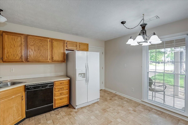 396 Squires Cir, Lexington, KY 40515 - kitchen featuring white refrigerator with ice dispenser, black dishwasher, a chandelier, light countertops, and pendant lighting
