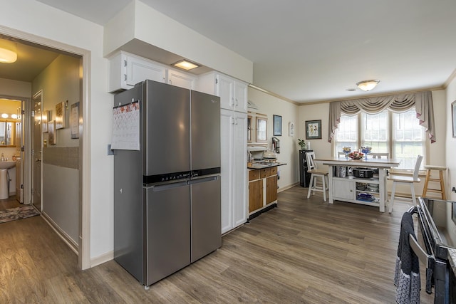 331 Clearbrook Dr, Danville, KY 40422 - kitchen featuring freestanding refrigerator, stove, white cabinets, dark wood finished floors, and ornamental molding