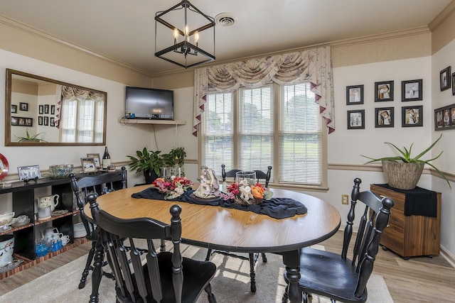 331 Clearbrook Dr, Danville, KY 40422 - dining room featuring light wood finished floors, a chandelier, healthy amount of natural light, and crown molding