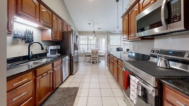 4368 River Oak Trl, Lexington, KY 40515 - kitchen featuring appliances with stainless steel finishes, dark stone countertops, and light tile patterned floors