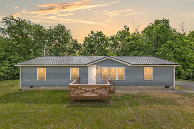 174 Sky Ln, Cynthiana, KY 41031 - back of house at dusk featuring crawl space, a lawn, a metal roof, and a wooden deck