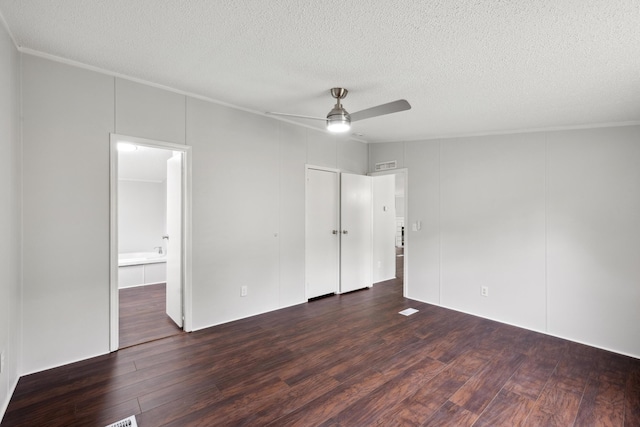 174 Sky Ln, Cynthiana, KY 41031 - unfurnished bedroom with dark wood-style flooring, a textured ceiling, connected bathroom, and ceiling fan