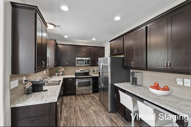 136 Meadowcrest Dr, Georgetown, KY 40324 - kitchen featuring appliances with stainless steel finishes, decorative backsplash, dark brown cabinetry, and recessed lighting