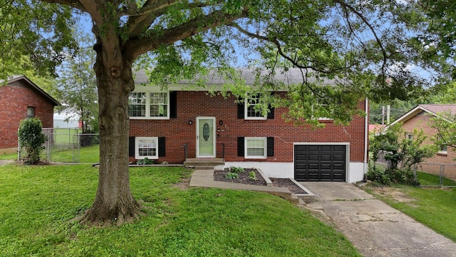 214 Southwind Dr, Winchester, KY 40391 - split foyer home featuring a garage, brick siding, and concrete driveway