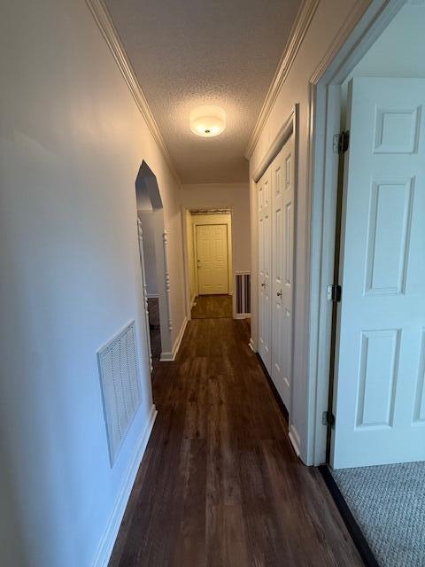 529 S 2nd St, Williamsburg, KY 40769 - corridor with arched walkways, ornamental molding, dark wood-style flooring, and a textured ceiling