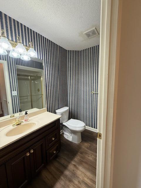 529 S 2nd St, Williamsburg, KY 40769 - bathroom featuring wallpapered walls, wood finished floors, vanity, an enclosed shower, and a textured ceiling
