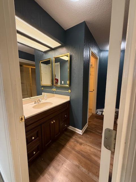529 S 2nd St, Williamsburg, KY 40769 - bathroom with wood finished floors, vanity, and a textured ceiling