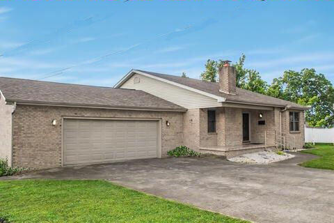 529 S 2nd St, Williamsburg, KY 40769 - ranch-style home with an attached garage, concrete driveway, a chimney, brick siding, and a front lawn