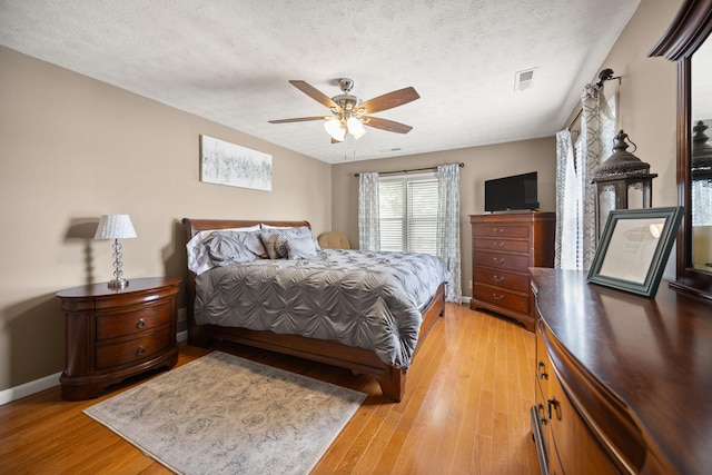 9209 W Hwy 80, Nancy, KY 42544 - bedroom featuring light wood-style floors, a textured ceiling, and ceiling fan