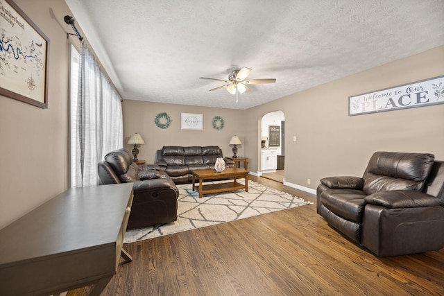 9209 W Hwy 80, Nancy, KY 42544 - living area with arched walkways, a ceiling fan, a textured ceiling, and wood finished floors