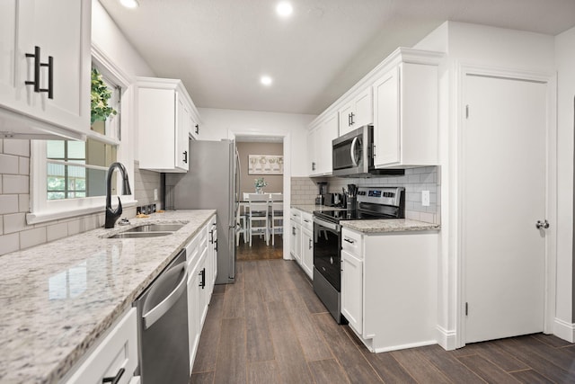 9209 W Hwy 80, Nancy, KY 42544 - kitchen with appliances with stainless steel finishes, dark wood-style flooring, white cabinets, recessed lighting, and tasteful backsplash