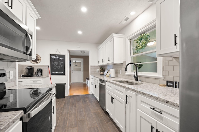 9209 W Hwy 80, Nancy, KY 42544 - kitchen with stainless steel appliances, backsplash, white cabinets, dark wood finished floors, and light stone counters