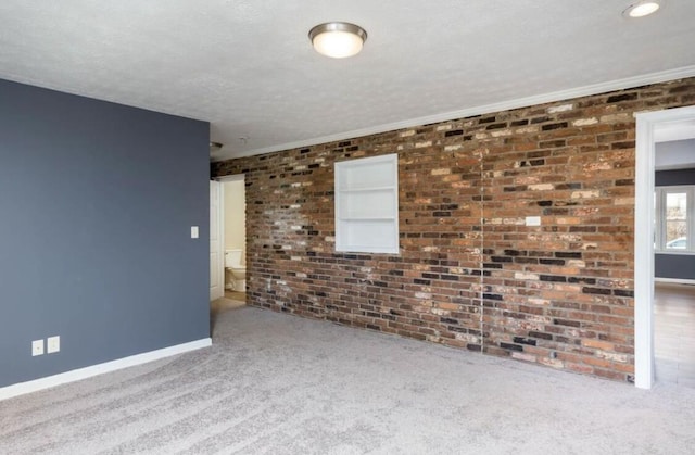 1984 Greenleaf Dr, Lexington, KY 40505 - carpeted spare room featuring brick wall and crown molding