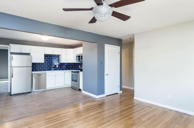 1984 Greenleaf Dr, Lexington, KY 40505 - kitchen featuring stainless steel appliances, tasteful backsplash, ceiling fan, white cabinets, and light wood-style floors