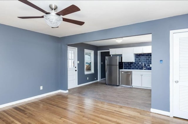 1984 Greenleaf Dr, Lexington, KY 40505 - kitchen featuring stainless steel appliances, white cabinets, light wood-type flooring, a ceiling fan, and backsplash