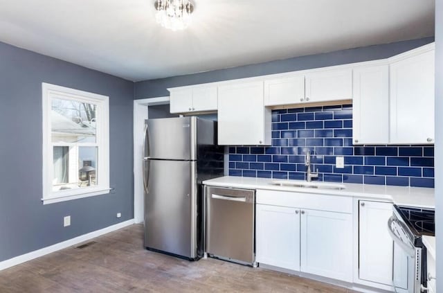 1984 Greenleaf Dr, Lexington, KY 40505 - kitchen featuring stainless steel appliances, light countertops, backsplash, light wood-style floors, and white cabinets
