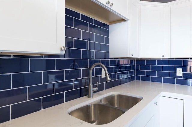 1984 Greenleaf Dr, Lexington, KY 40505 - kitchen with light stone counters, white cabinetry, and backsplash