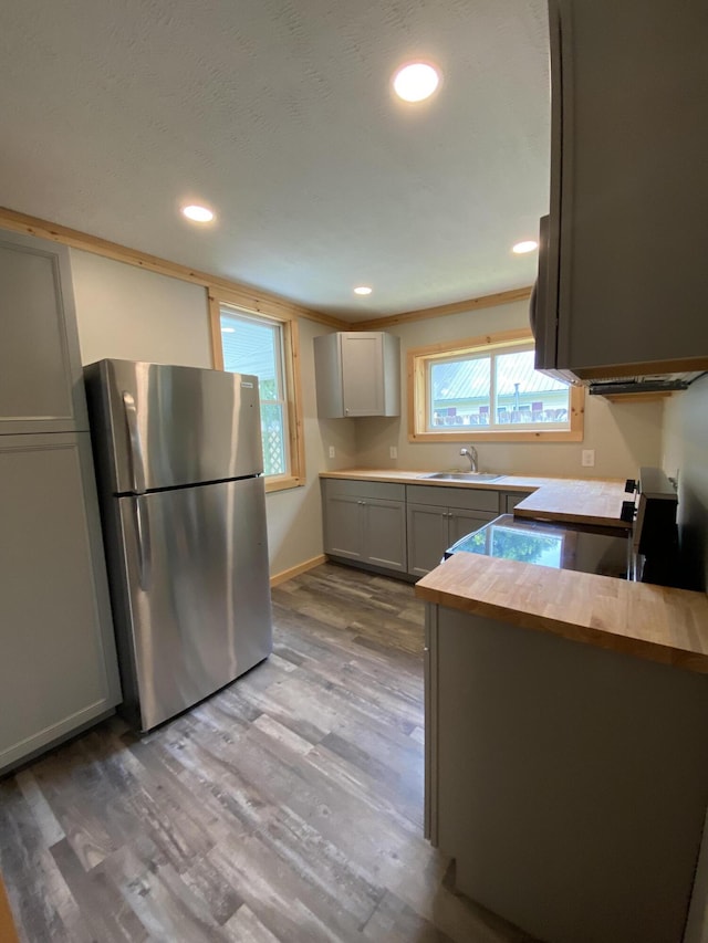618 N College St, Somerset, KY 42503 - kitchen with freestanding refrigerator, wood counters, light wood-style floors, plenty of natural light, and recessed lighting