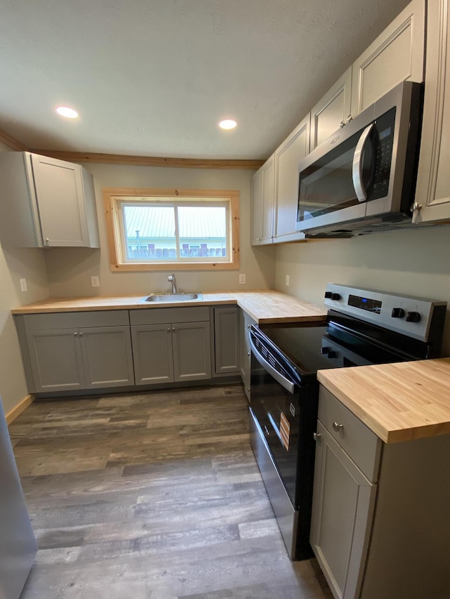618 N College St, Somerset, KY 42503 - kitchen with appliances with stainless steel finishes, butcher block countertops, dark wood finished floors, recessed lighting, and gray cabinetry