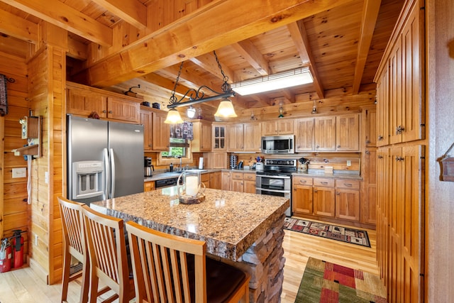 1564 High Ridge Rd, Middleburg, KY 42541 - kitchen with stainless steel appliances, light wood-style flooring, a wood ceiling with exposed beams, a center island, and wood walls