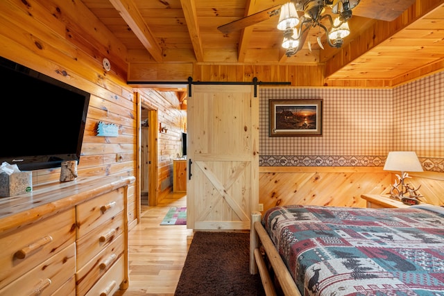 1564 High Ridge Rd, Middleburg, KY 42541 - bedroom with a barn door, wooden walls, a wood ceiling with exposed beams, and light wood-style floors