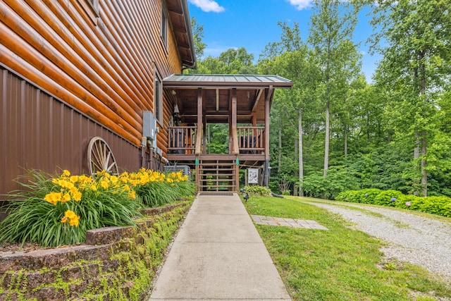 1564 High Ridge Rd, Middleburg, KY 42541 - doorway to property featuring faux log siding, a yard, and a metal roof