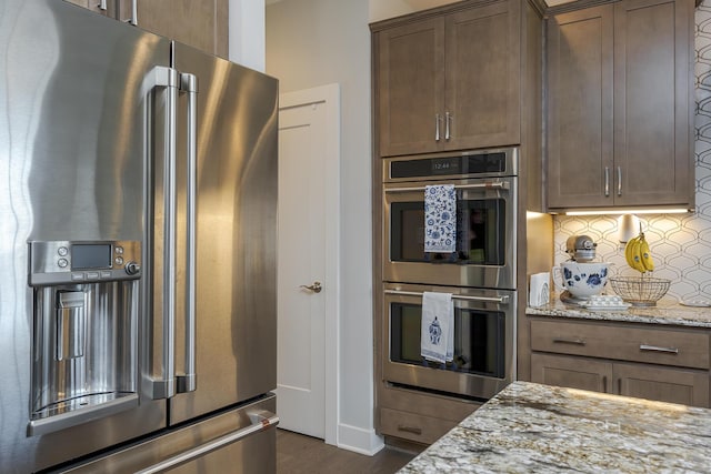 3536 Night Heron Way, Lexington, KY 40515 - kitchen with stainless steel appliances, tasteful backsplash, light stone countertops, and dark wood finished floors