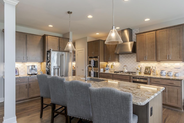 3536 Night Heron Way, Lexington, KY 40515 - kitchen featuring stainless steel appliances, wall chimney range hood, dark wood-style floors, a breakfast bar, and recessed lighting