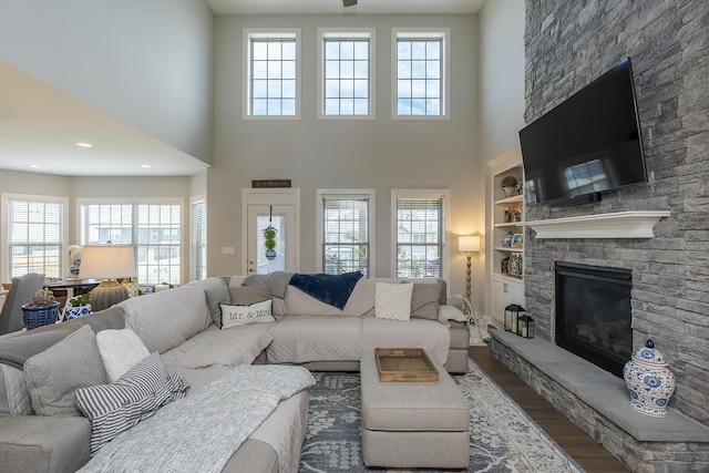 3536 Night Heron Way, Lexington, KY 40515 - living area featuring wood finished floors, healthy amount of natural light, a stone fireplace, and a high ceiling