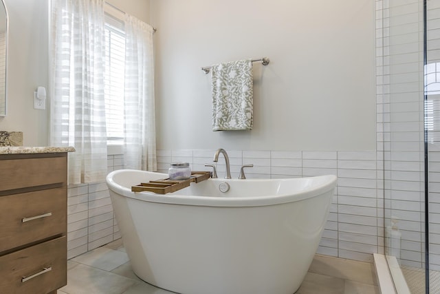 3536 Night Heron Way, Lexington, KY 40515 - bathroom featuring tile walls, vanity, tile patterned floors, a freestanding tub, and wainscoting