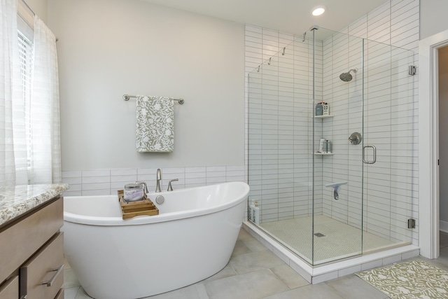 3536 Night Heron Way, Lexington, KY 40515 - bathroom featuring a freestanding tub, a shower stall, vanity, tile patterned floors, and tile walls