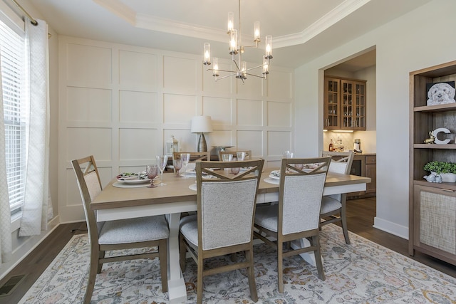 3536 Night Heron Way, Lexington, KY 40515 - dining area with a decorative wall, crown molding, dark wood-type flooring, and a chandelier
