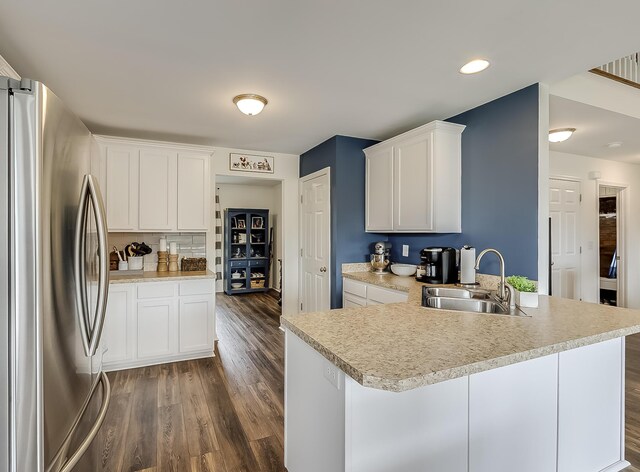 1011 Brown Store Rd, Lawrenceburg, KY 40342 - kitchen featuring freestanding refrigerator, a peninsula, light countertops, dark wood-type flooring, and white cabinetry
