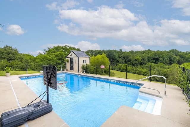 1011 Brown Store Rd, Lawrenceburg, KY 40342 - outdoor pool featuring a patio area, an outbuilding, and a wooded view