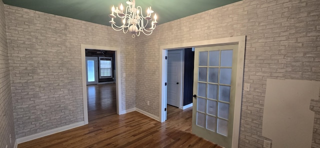 4020 Greentree Rd, Versailles, KY 40383 - unfurnished dining area with brick wall, wood finished floors, and a chandelier