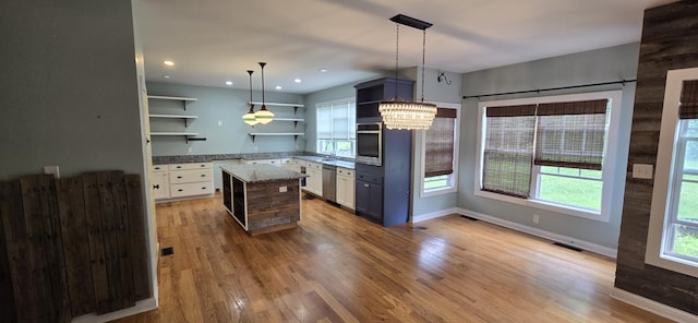 4020 Greentree Rd, Versailles, KY 40383 - kitchen featuring open shelves, appliances with stainless steel finishes, light wood-style floors, a center island, and pendant lighting