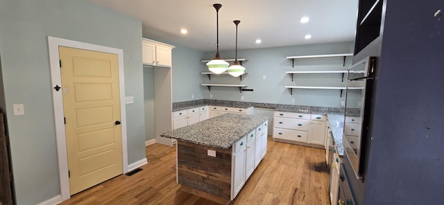 4020 Greentree Rd, Versailles, KY 40383 - kitchen with open shelves, light wood-type flooring, white cabinets, light stone countertops, and recessed lighting