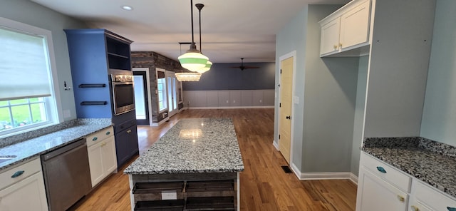 4020 Greentree Rd, Versailles, KY 40383 - kitchen with appliances with stainless steel finishes, light wood-style floors, light stone countertops, and a wainscoted wall