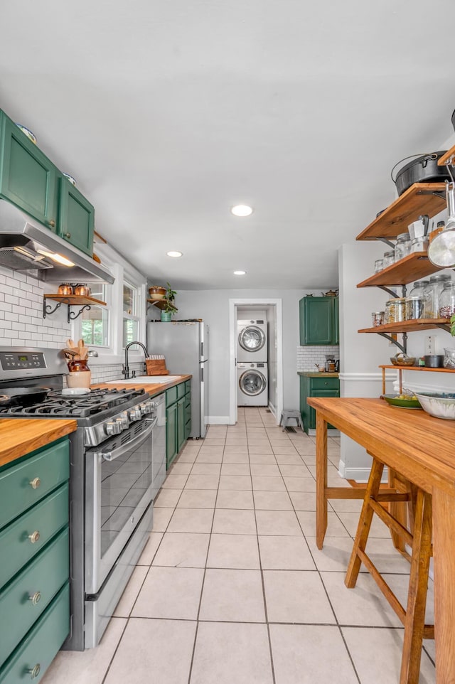334 Oldham Ave, Lexington, KY 40502 - kitchen featuring stainless steel appliances, green cabinets, stacked washer / drying machine, under cabinet range hood, and light tile patterned flooring