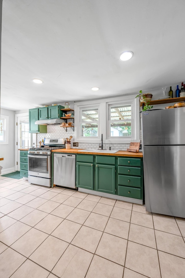 334 Oldham Ave, Lexington, KY 40502 - kitchen with appliances with stainless steel finishes, green cabinets, under cabinet range hood, backsplash, and recessed lighting