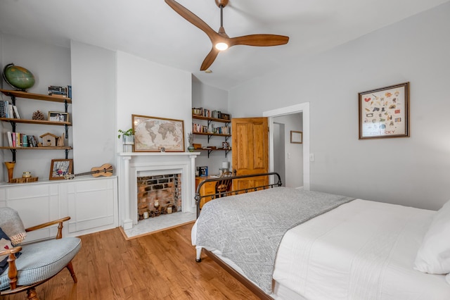 334 Oldham Ave, Lexington, KY 40502 - bedroom with light wood-type flooring, a fireplace with flush hearth, and ceiling fan