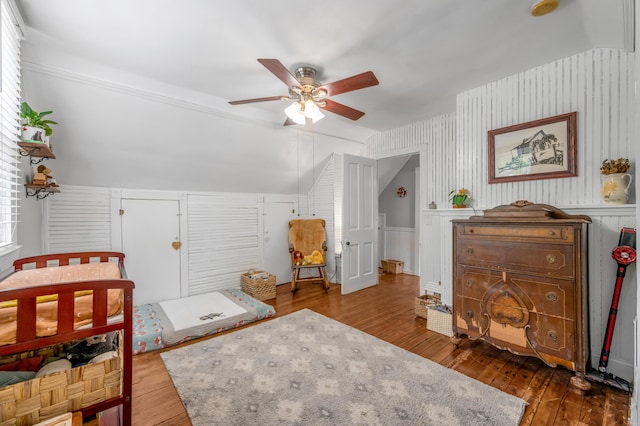 334 Oldham Ave, Lexington, KY 40502 - bedroom featuring hardwood / wood-style floors, vaulted ceiling, wallpapered walls, a ceiling fan, and a wainscoted wall